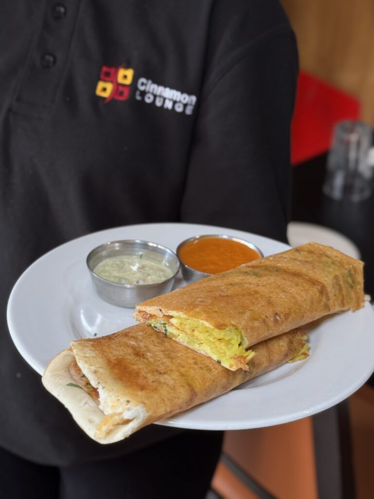 Crispy South Indian masala dosa served with coconut chutney and sambar at Cinnamon Lounge.