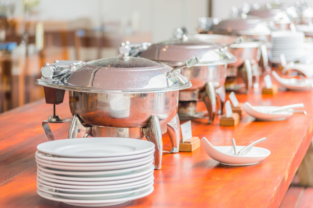 Professional-buffet-catering-setup-with-chafing-dish-warmers-and-dinnerware-at-Lebanese-Village.