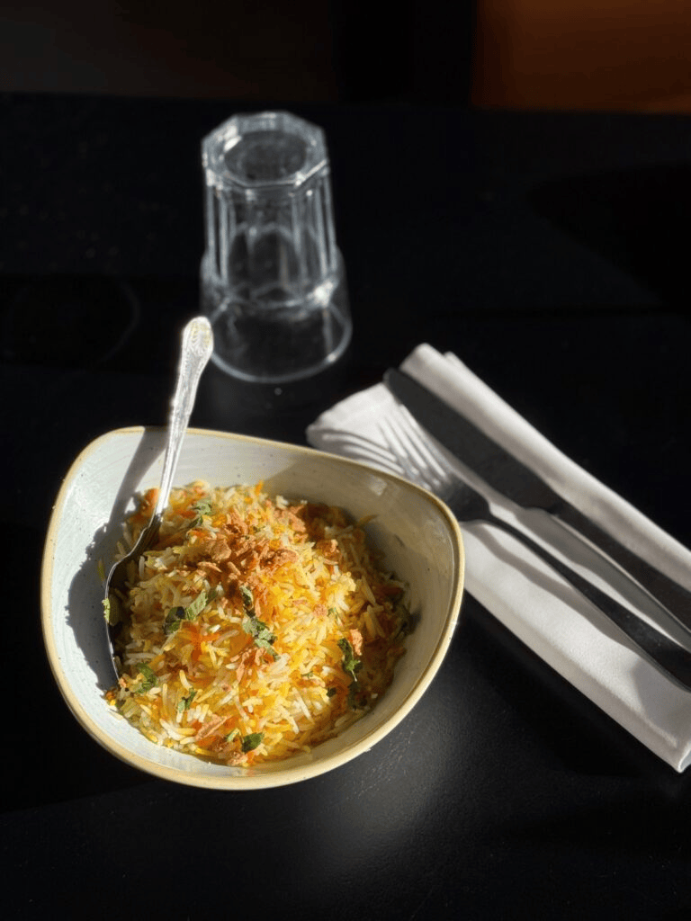Saffron basmati rice biryani topped with crispy onions and herbs served at Cinnamon Lounge