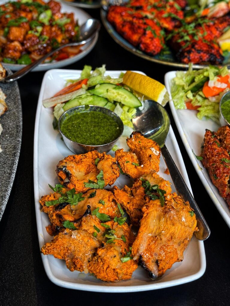 Sizzling grilled chicken tikka platter served with mint chutney at Cinnamon Lounge.