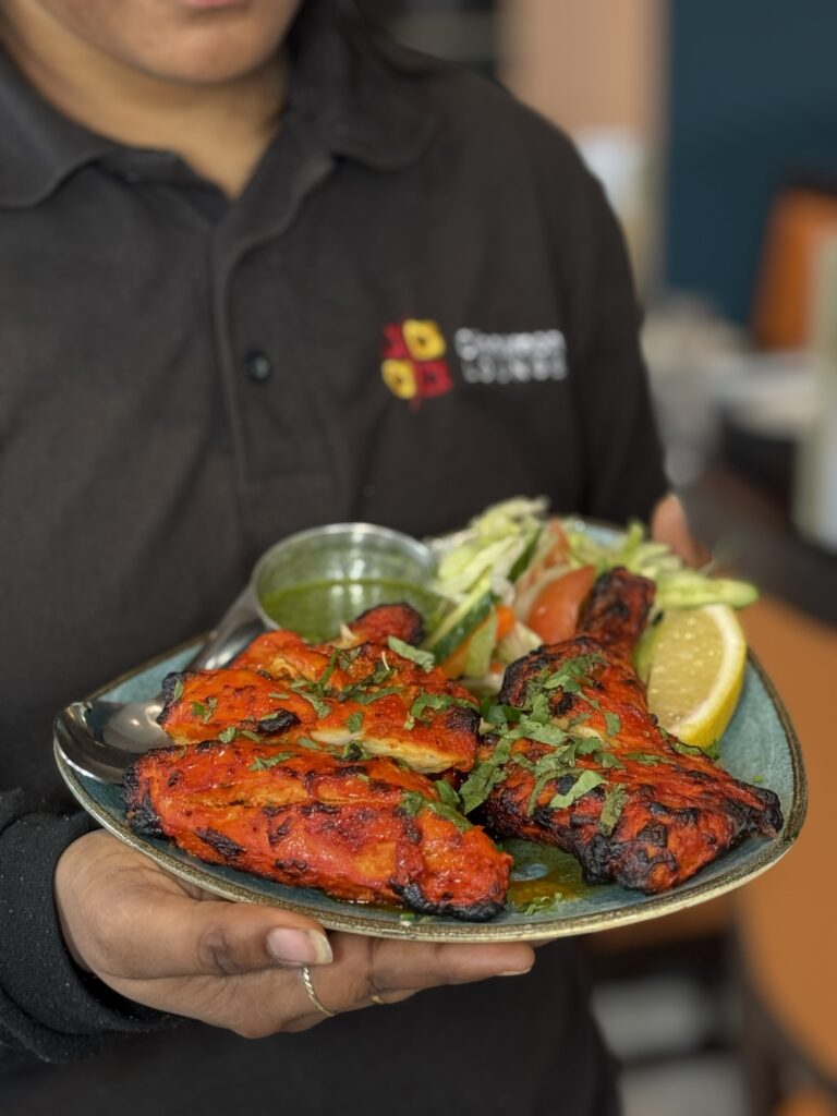 Sizzling-tandoori-chicken-quarter-platter-served-with-mint-chutney-and-fresh-salad-at-Cinnamon-Loung