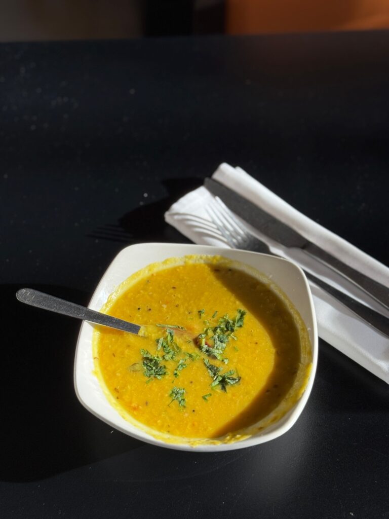 Yellow dal lentil curry garnished with fresh cilantro served at Cinnamon Lounge.