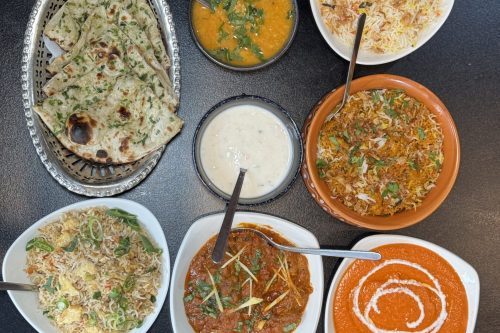 Authentic Indian feast with garlic naan, biryani, and butter chicken at Cinnamon Lounge.